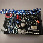 Vintage costume jewelry featuring necklaces, silver-toned pendants, and earrings