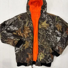 Boys reversible bushmaster jacket Camo one side orange other side. Size 14-16