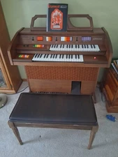 Small, Vintage Kimball Superstar Organ with music bench for holding music books.