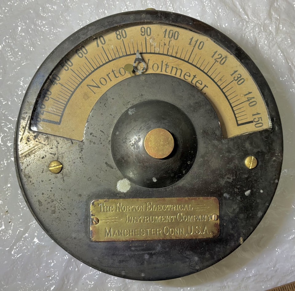 An 1890s heavy brass Norton voltmeter that's essentially wearable history — a stunning analog scientific relic from the dawn of electrical measurement.