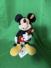 Steiff Mickey Mouse holding a bear