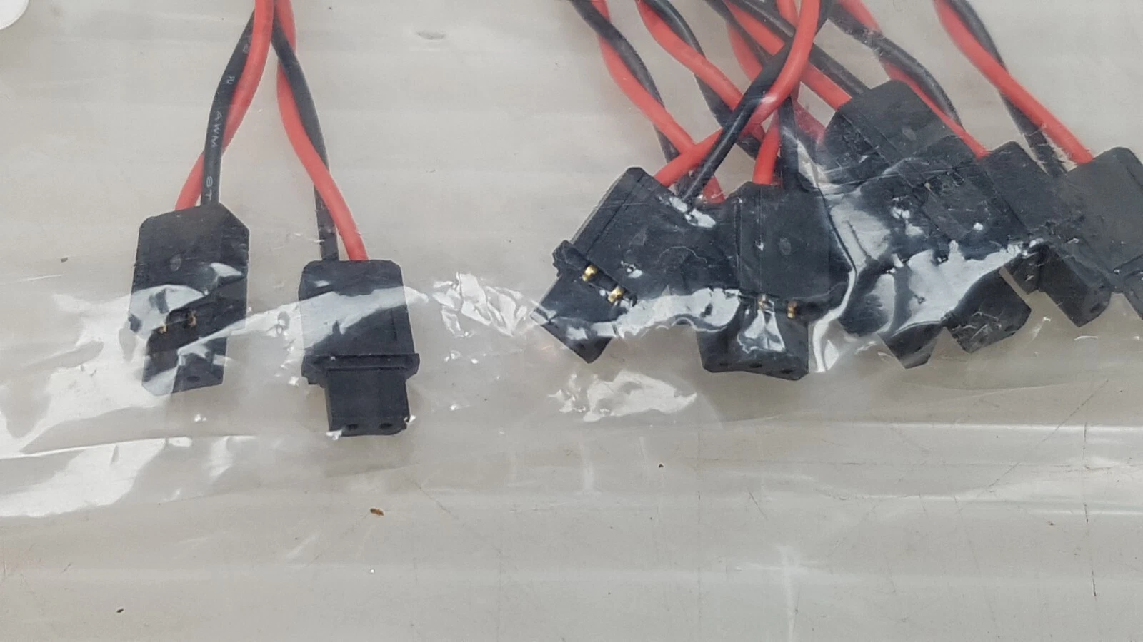 Black 2-pin connectors on the HS-10067100 harness cables