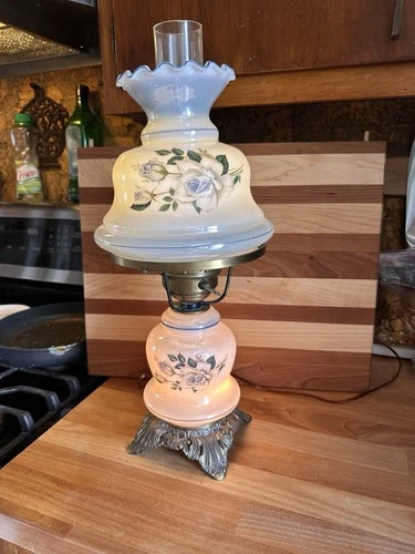 Vintage milk glass hurricane lamp with blue floral decoration.