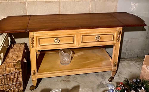 Vintge dining room sideboard on brass casters. Top can be expanded, one drawer.