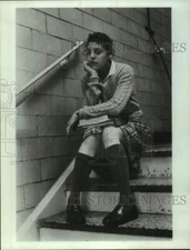 Press Photo Actress sits on stairs with books in scene - sap40151