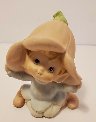 Seated Baby Green Elf Pixie Leprechaun Figurine Holding Shamrocks Clovers Peapod Green Suit Flower Hat Brown Hair Japan 1970s