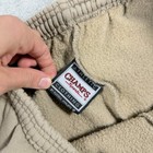 Tan khaki Russell Athletic Champs men’s XL sweatpants with elastic cuffs, front pockets, and visible “ATHLETIC Sports” tag.