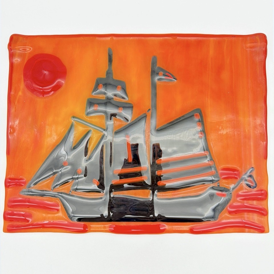 Hand-fused glass wall art of a sailing ship in fiery orange and red — one-of-a-kind studio craft piece you simply cannot find in any store today.