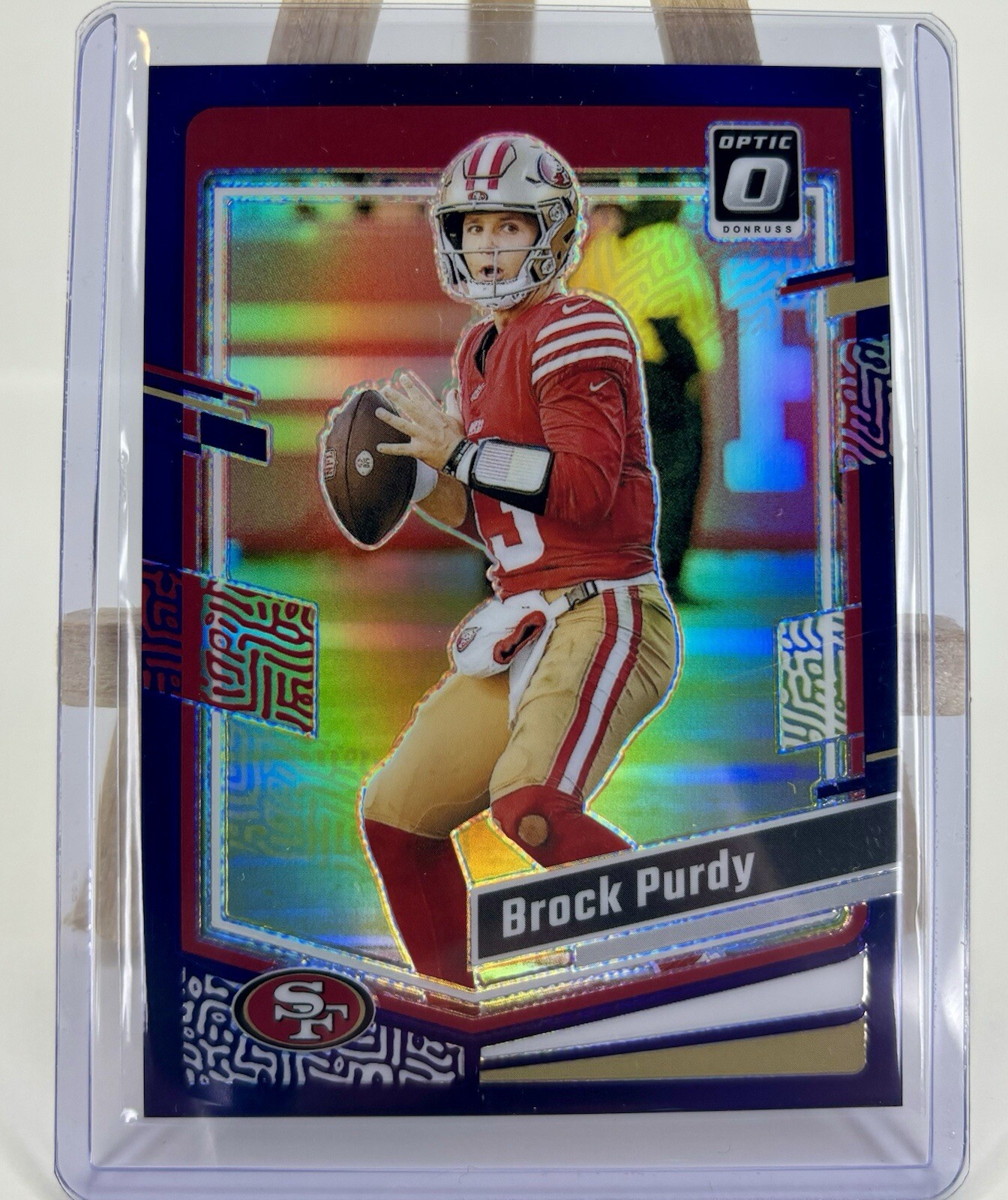 2023 Panini Optic Football Brock Purdy #168 Purple Prizm 43/50 49ers