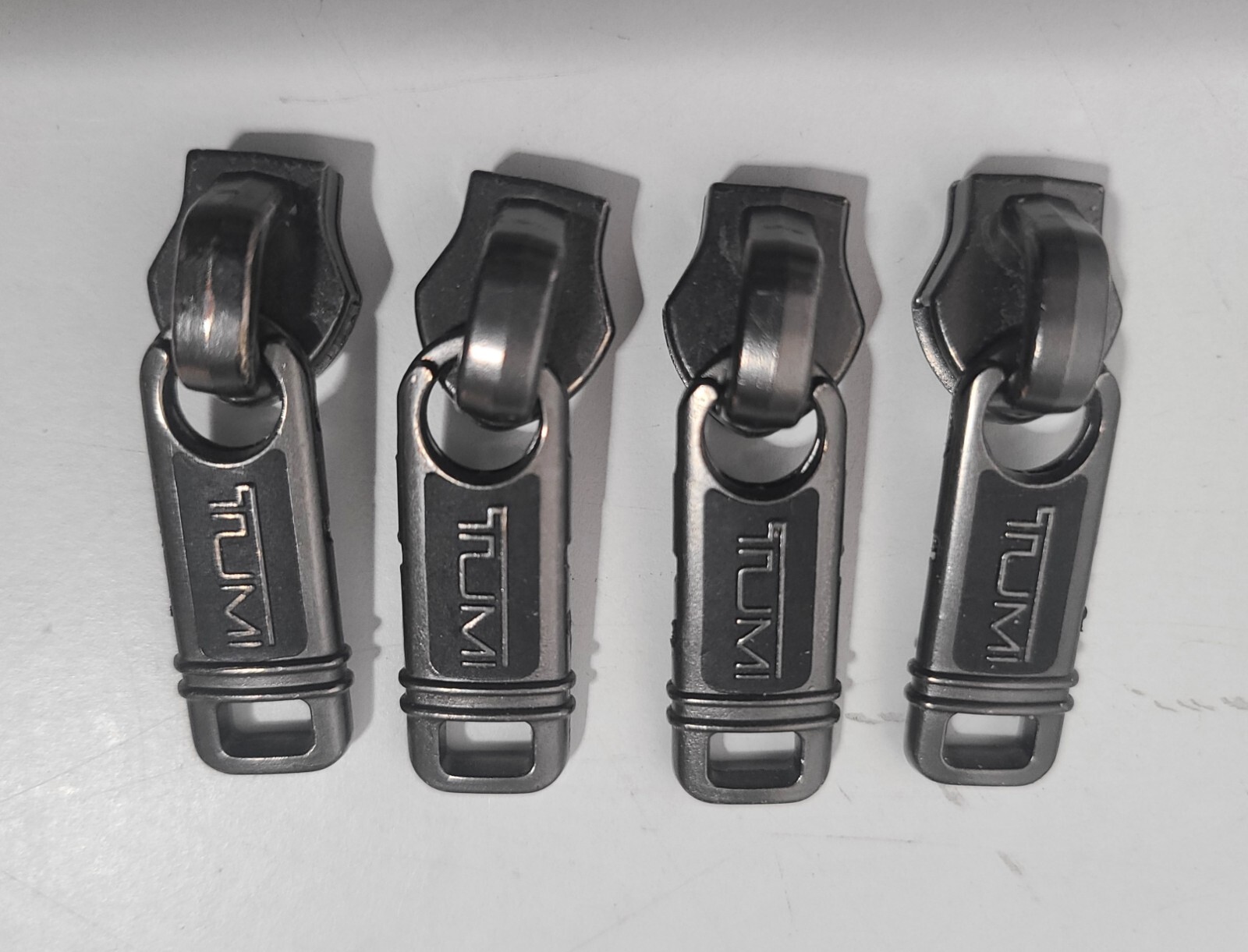 Four TUMI Zippers head/pull for Sale. eBay