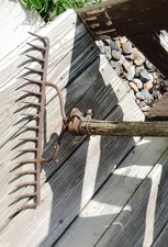 Authentic farm vintage metal rake with very old worn out handle, primitive 1900s