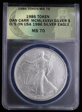 1986 Token Dan Carr MCMLXXXVI Silver $ O/S on USA Silver Eagle ANACS MS70