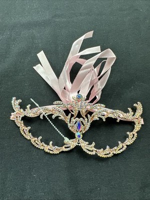 delicate rose gold masquerade mask adorned with iridescent rhinestones.