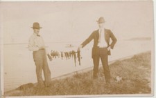 PHOTO OF WELL-DRESSED FISHERMEN W/ STRINGED FISH CATCH