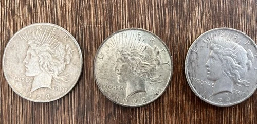 THREE 1923 BRIGHT UNC PEACE SILVER DOLLARS.   394