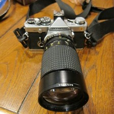 OLYMPUS OM-2N 35 MM FILM CAMERA W/TOKINA AT-X 35-20 MM 1:35-45 LENSE AND STRAP