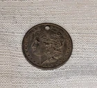 1887 Silver Liberty Morgan Dollar Hole In Coin. Overall good condition.