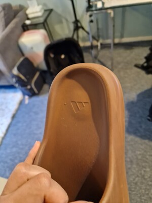 brown yeezy slides on feet