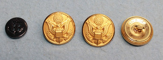 Four Military uniform buttons. Three brass army dress uniform and one Navy