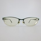 Danze green semi-rimless oval eyeglass frames with silver lenses and engraved feather motifs on the front corners.