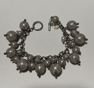 Silver-tone bracelet  cha-cha'' style beads, single faux pearl and toggle clasp.