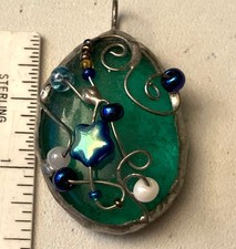 Handcrafted wire-wrapped green art glass pendant
