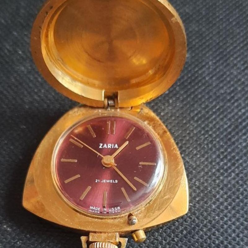 A Soviet-era Zaria 21-jewel mechanical pendant watch in gold-plated Au5 — USSR watchmaking at its most elegant and collectible.