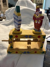 Vintage wooden toy with clowns and a wheel to make them turn. Folk toy