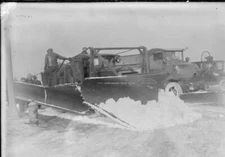 Man Standing On A Snow Plow With His Back To The Camera On A Stre - Old Photo