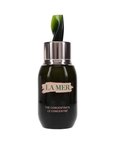 Dark bottle of La Mer The Concentrate 1.7 oz / 50ml with green cap, white label, and green leaf accents.
