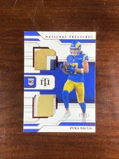 2023 National Treasures Rookie Dual Materials Puka Nacua #RDM-28 Red 7/17 RC