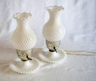A pair of vintage white hobnail milk glass table lamps.