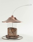Copper-toned 53002 Farmer’s Delight wild bird food dispenser with clear plastic lens and long wire hanging loop.