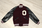 Maroon varsity jacket with black leather sleeves, white buttons, and large white “O” logo on front, size 38.