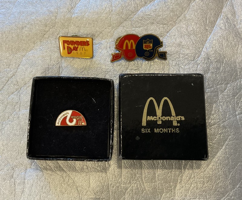 McDonalds pins (4) Two employee service pin and two others given away.