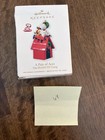 2014 Hallmark Keepsake officer Snoopy #17 ornament in red doghouse with “A Pair of Aces” text on front.