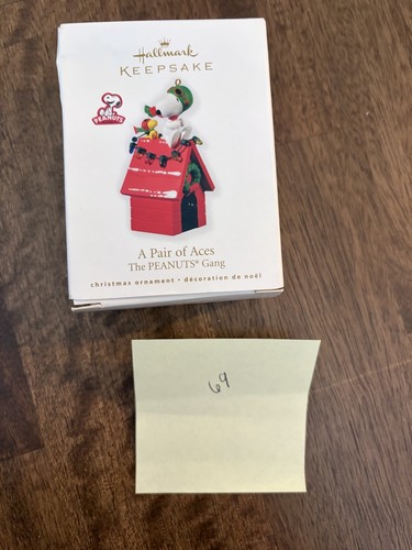 2014 Hallmark Keepsake officer Snoopy #17 ornament in red doghouse with “A Pair of Aces” text on front.