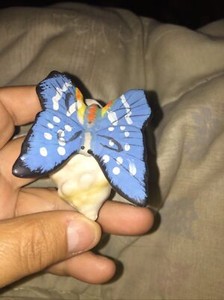 Ceramic seashell with a butterfly on top