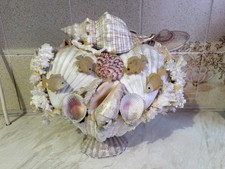 A Handmade Decorative Seashell Arrangement with Molded Fish Figures On A Base