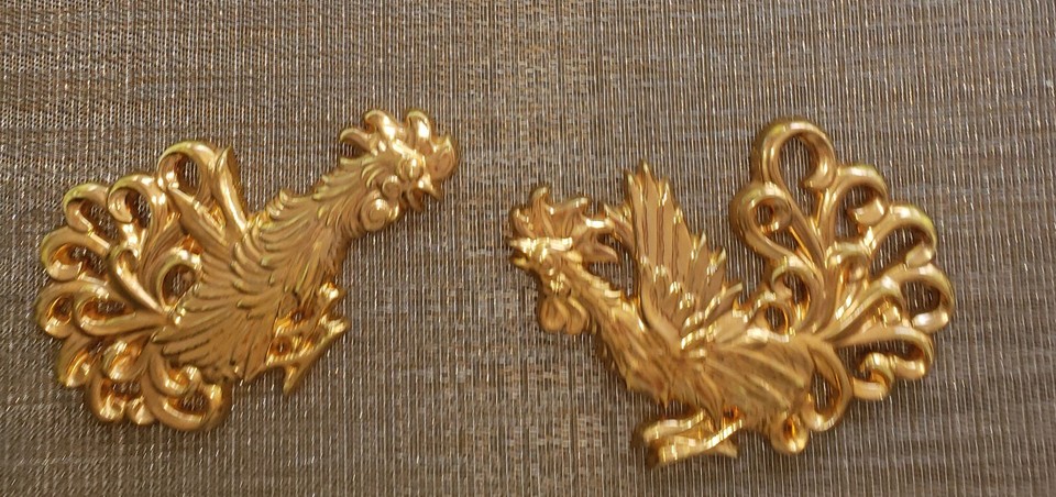 A pair of gilded ceramic fighting roosters — the quintessential kitschy MCM wall art that's had a massive design revival and looks insanely cool in the right room.