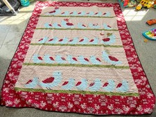 Multicolor 89 X 98 quilt with blue and red bird families, solid black back