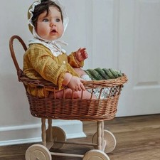 NATURAL Simple wicker doll pram with bedding included.