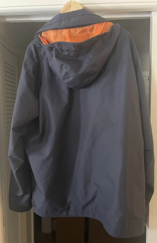 Nueva chaqueta con capucha impermeable Orvis Wahoo para hombre con capucha guardable XL azul marino Foto 3 de 4