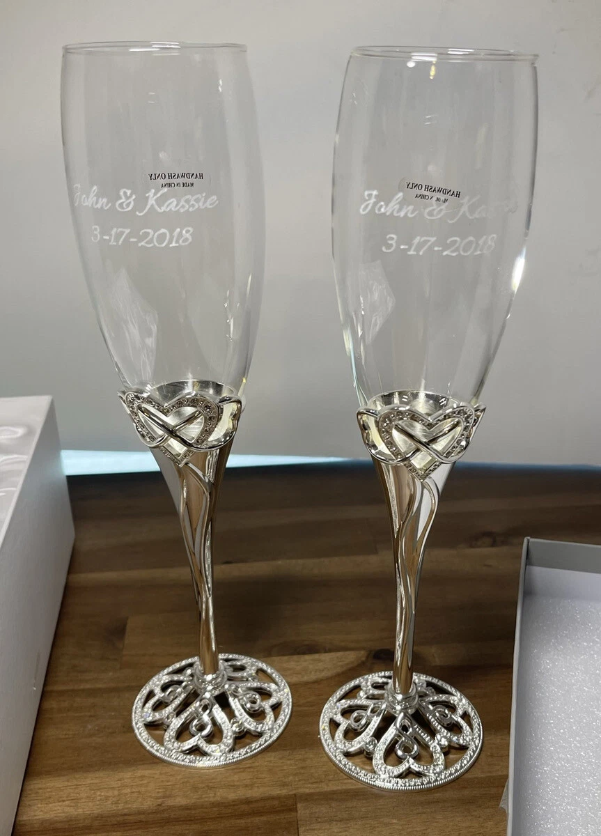 Champagne toast. Two filled champagne flutes touch in a spill over