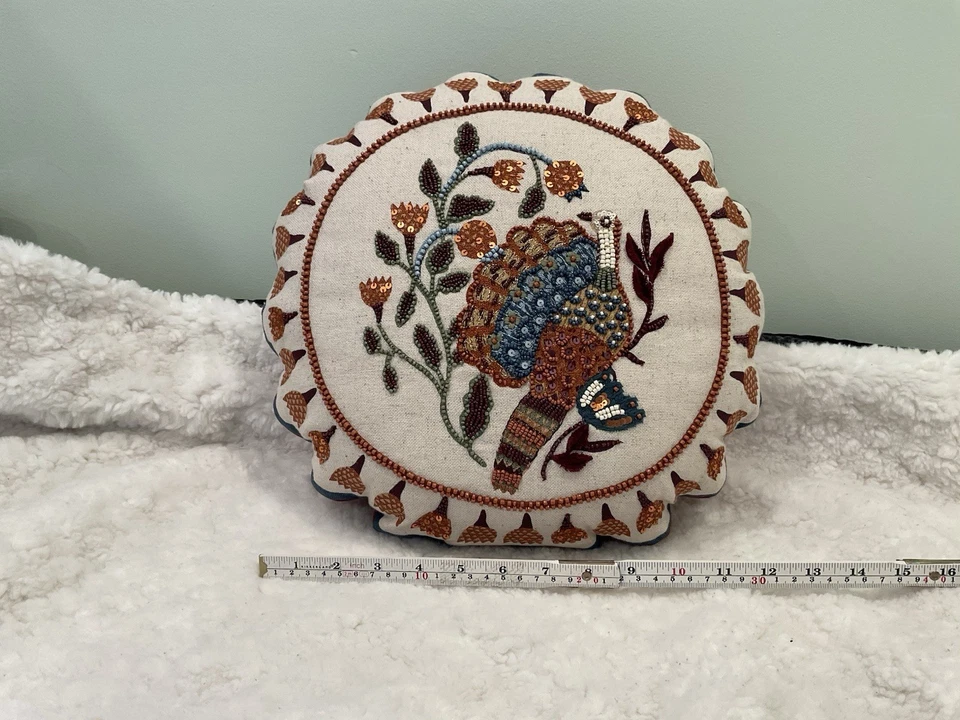 The round decorative throw pillow and beaded design of a Peacock. - Image 2 of 4