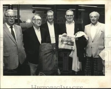 1983 Press Photo Golfers pose with luggage & newspaper article in New York