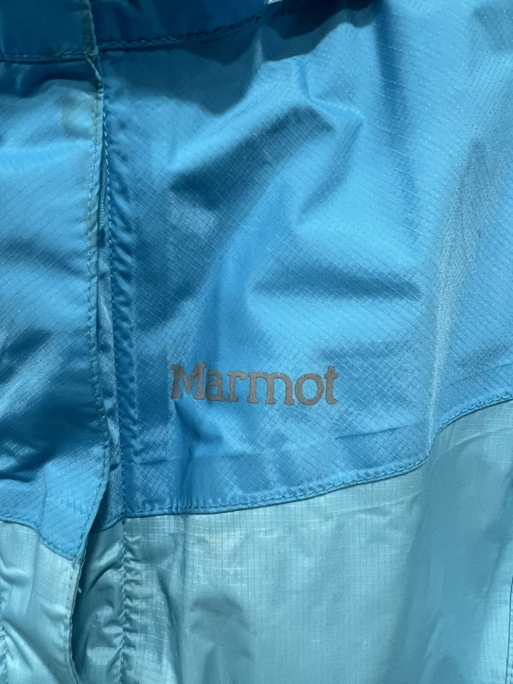 Chaqueta cortavientos de lluvia Marmot para niñas talla grande verde azulado turquesa nailon con capucha Foto 2 de 4