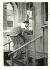 1986 Press Photo Daniel Burke Repairs St. Lucy's Church Back Door - syp46517