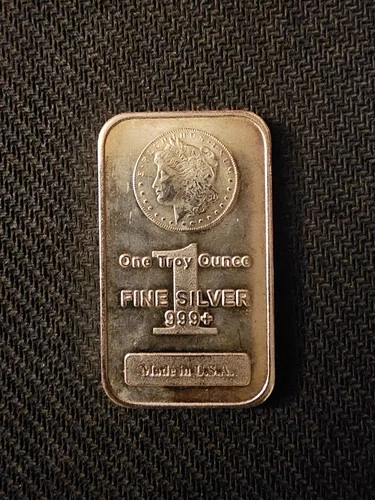 1 Troy Ounce .999 fine silver bar featuring a classic Morgan Dollar design.