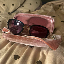 Miu Miu Women  s Cat Eye Sunglasses Black Frame Gray Tinted Lenses, Pink Case